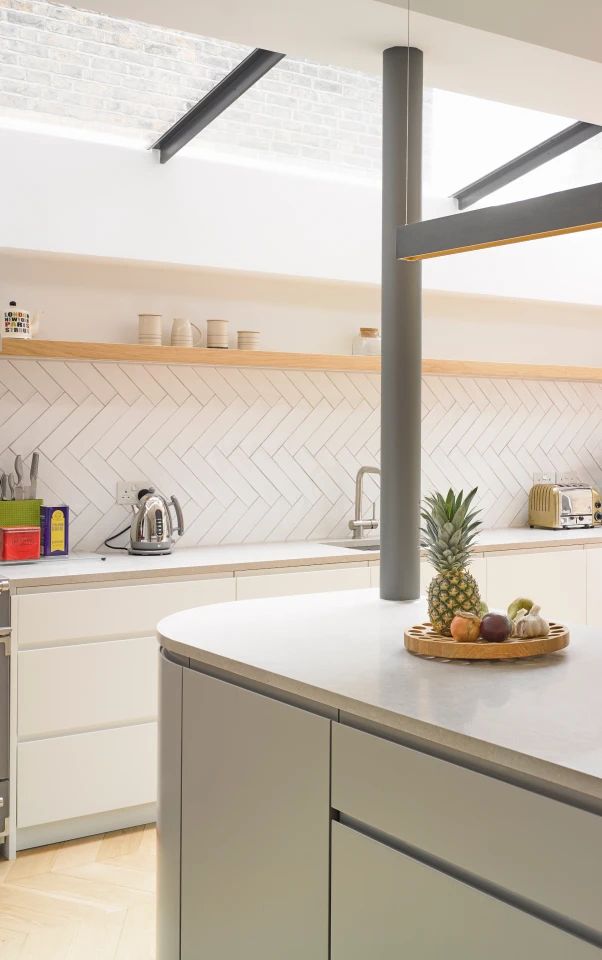 A grey kitchen showing a skylight up above