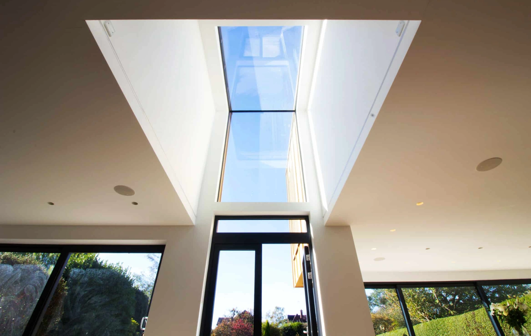 Eaves skylight above doorway letting natural light shine in
