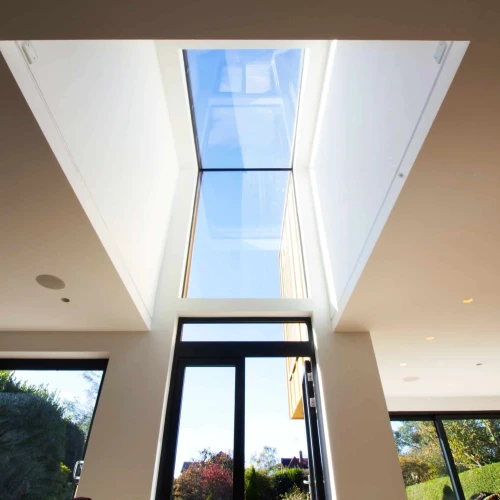 Eaves skylight above doorway letting natural light shine in