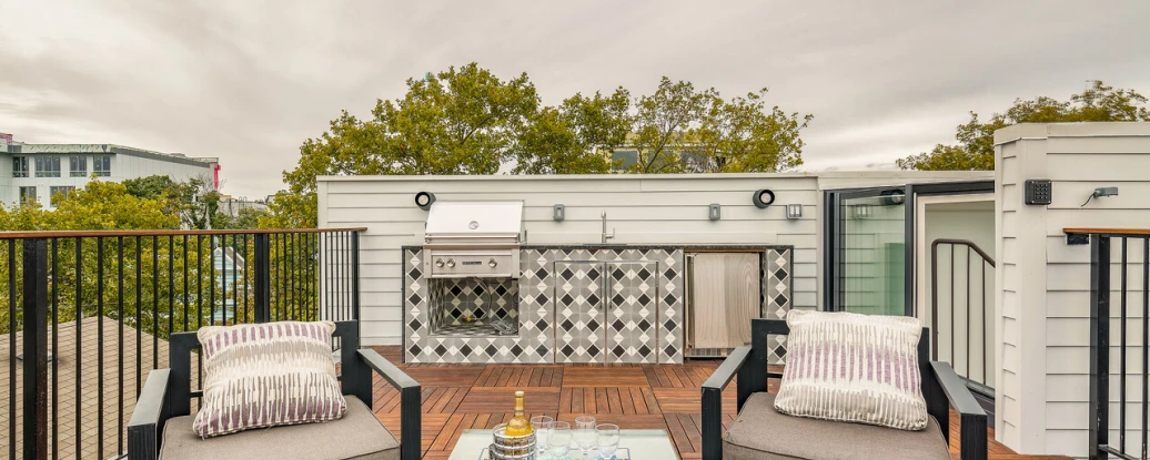 On wooden terrace showing two chairs facing you and then in the corner there is a skybox leading onto the terrace