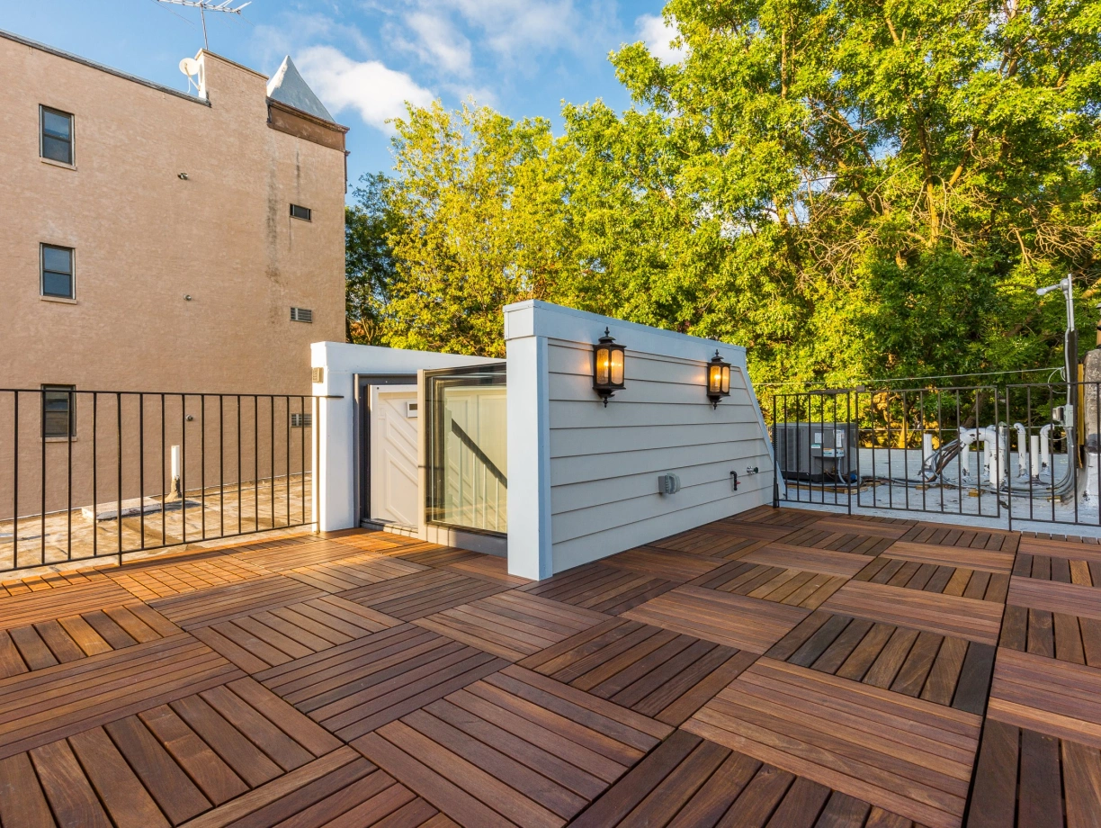 box skylight surrounded by white wooden panels installed on a roof terrace