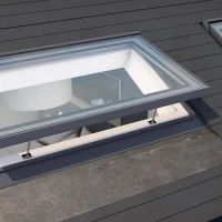 Skylights set into a sloped roof, allowing natural light to illuminate the interior. The roof features dark shingles, and the skylights have a modern design with clear glass frames.